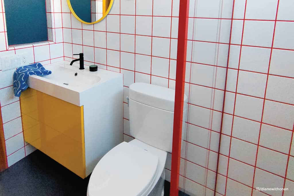 Stylish yellow Ikea cabinet in small bathroom